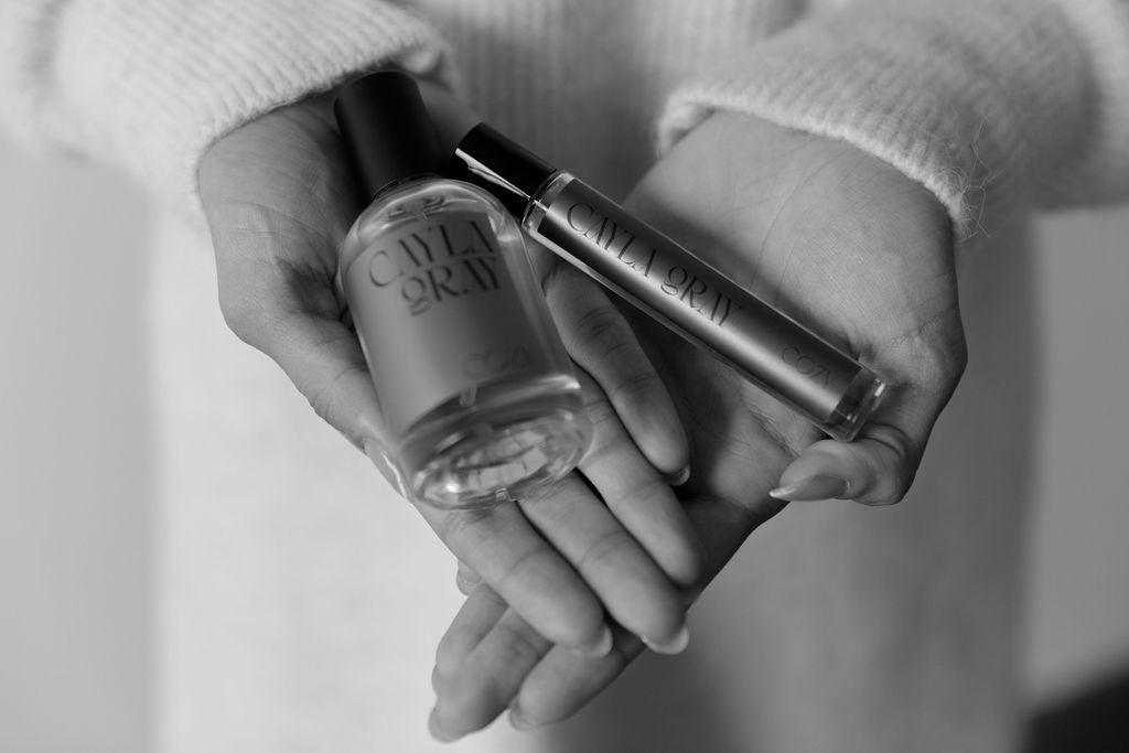 Cozy Perfume and Rollerball being held in hands