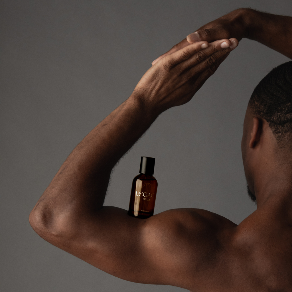 Man holding Legacy the Fragrance on his arm